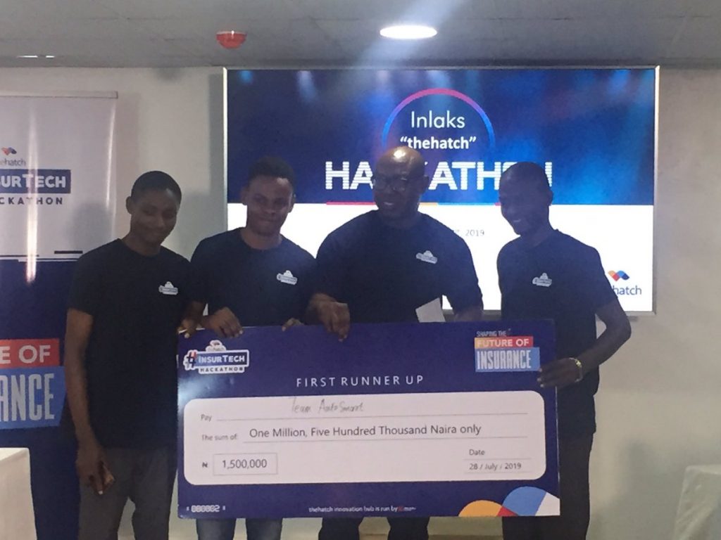 Femi Adeoti presenting prize to first runner-up at the insurance hackathon
