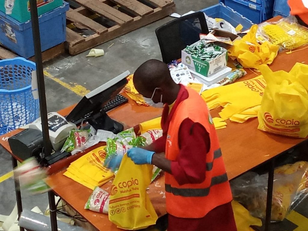 A CopiaKenya worker sorts items for delivery.